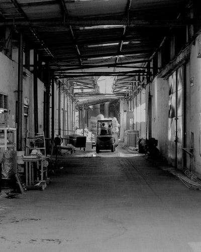 Forklift transporting material down a hallway. 