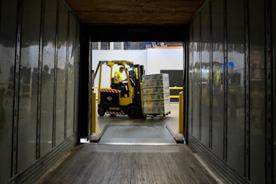 Forklift loading a trailer for transport. 