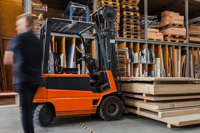 Small toyota forklift moving wood. 
