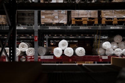 Warehouse rack with carpet rolls. 